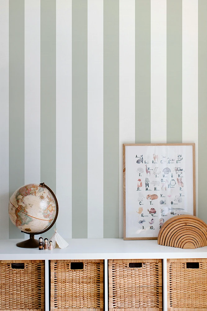 Striped kids wallpaper with a shelf featuring a globe, framed picture, and woven baskets.
