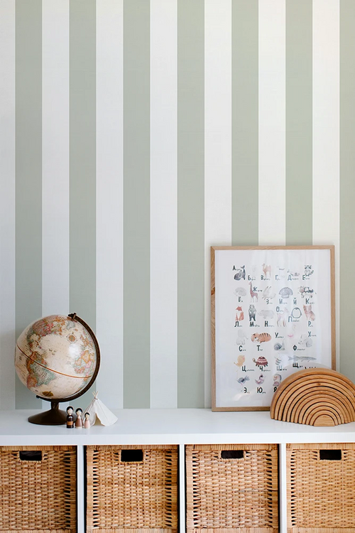 Striped kids wallpaper with a shelf featuring a globe, framed picture, and woven baskets.