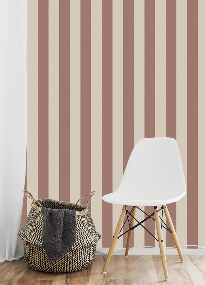 White chair and woven basket against striped brown kids wallpaper