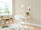 Children's room with a desk, shelves, and striped yellow wallpaper.