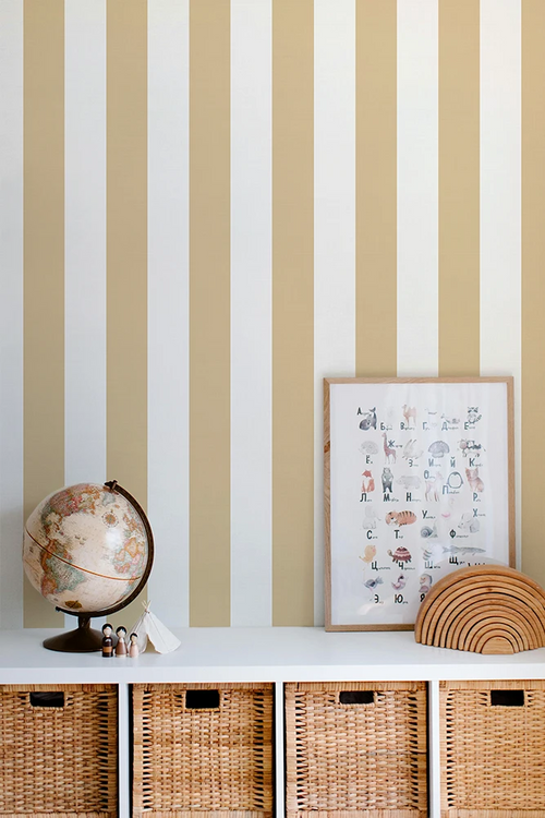 Striped yellow wallpaper with a shelf featuring a globe, framed picture, and woven baskets.