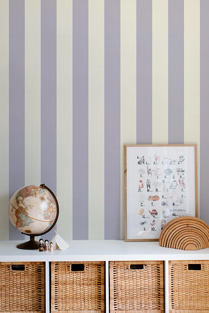 Striped kids wallpaper with a shelf featuring a globe, framed picture, and woven baskets.
