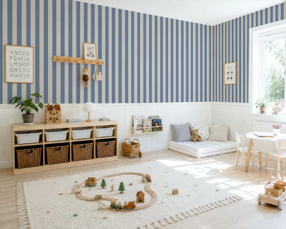 Children's playroom with blue and white striped wallpaper, wooden shelves, and toys on a rug.