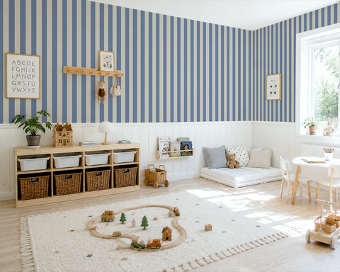 Children's playroom with blue and white striped wallpaper, wooden shelves, and toys on a rug.
