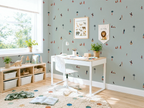 Children's room with a desk, chair, and decorative kids wallpaper pattern of a sunny beach. 