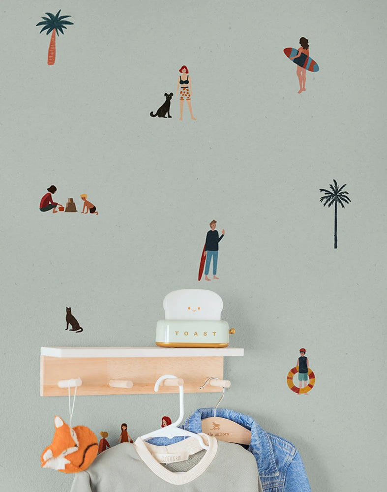Kids wallpaper pattern with people, palm trees, and a dog on a light green background.