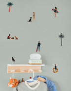 Kids wallpaper pattern with people, palm trees, and a dog on a light green background.