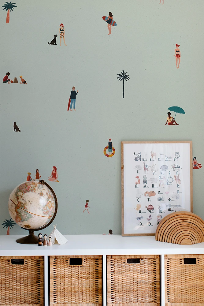 Kids wallpaper with a beach pattern, a framed poster, and wicker baskets.