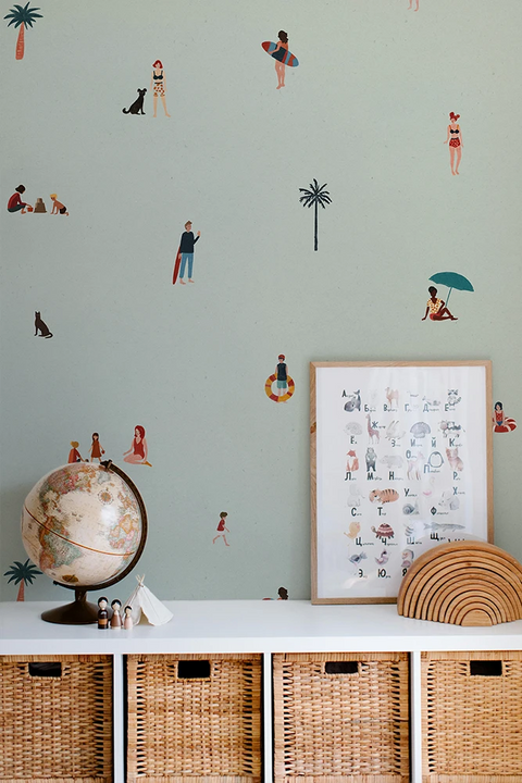 Kids wallpaper with a beach pattern, a framed poster, and wicker baskets.