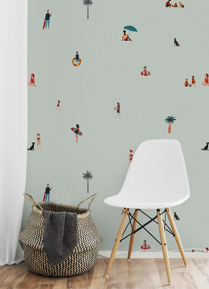White chair and woven basket against a wall with kids beach wallpaper