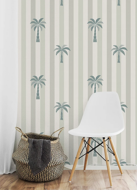 White chair and woven basket against striped wallpaper with palm tree design