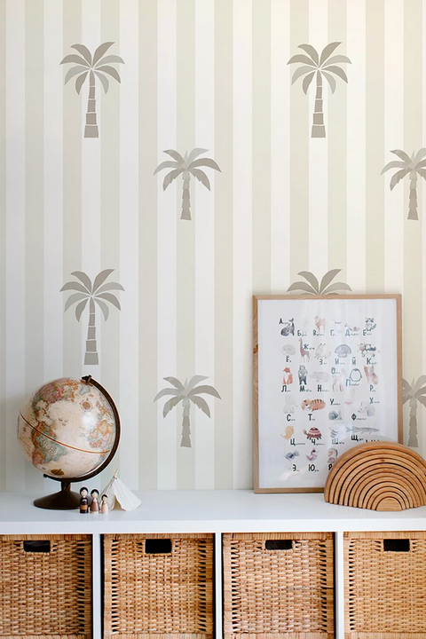 Wall with palm tree kids wallpaper framed picture, globe, and woven baskets.