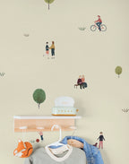 Wall with kids wallpaper illustrations of people and nature on a light beige background