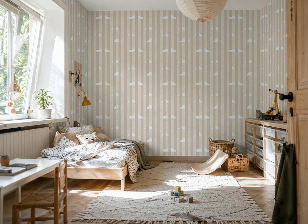 Nursery room with striped cloud wallpaper, wooden crib, and toys on a rug.