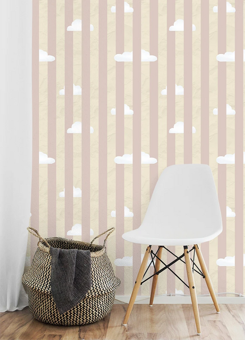 White chair and woven basket against a wall with pink wallpaper stripes and white clouds