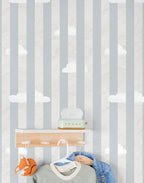 Children's room with striped cloudy wallpaper, shelves, and toys.
