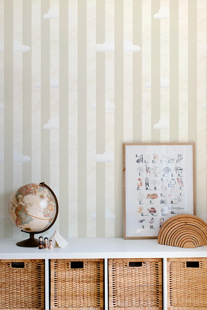 Decorative shelf with wicker baskets, a globe, and a framed print against a striped yellow wallpaper.