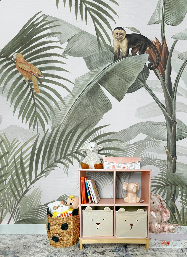 Children's room with a jungle-themed wallpaper, bookshelf, and toys.