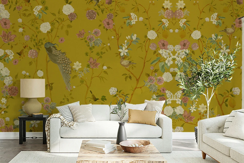 Living room with floral chinoiserie wallpaper, white sofa, and decorative elements.