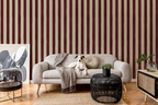 Living room with burgundy striped wallpaper, gray sofa, and decorative items.
