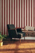 Chair in a room with red and white striped wallpaper