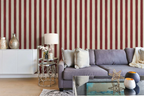 Living room with a gray sofa against a red and white striped wallpaper.