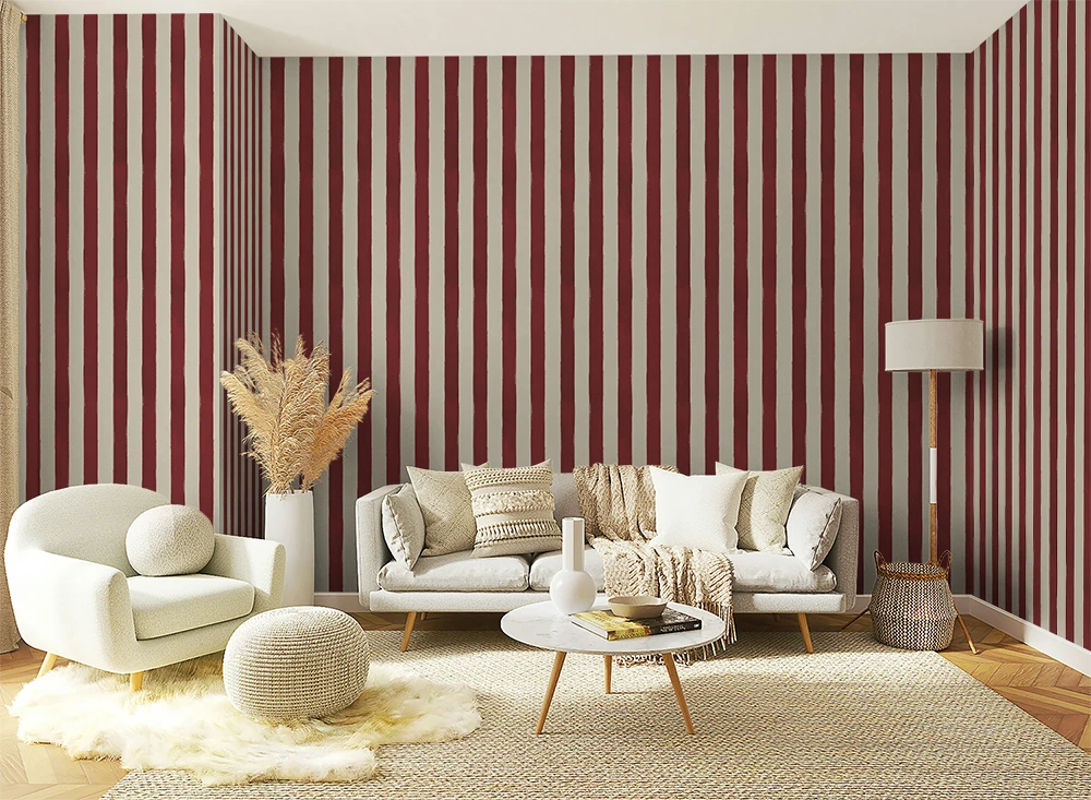 Living room with red and white hand drawn striped wallpaper, white sofa, and decorative items.