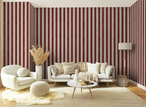 Living room with red and white hand drawn striped wallpaper, white sofa, and decorative items.