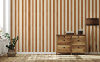 Wooden dresser against a wall with vertical striped caramel wallpaper pattern