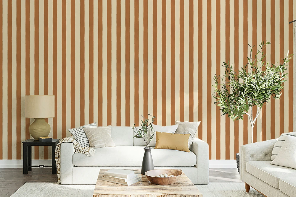 Living room with striped brown wallpaper, white sofa, and decorative elements.