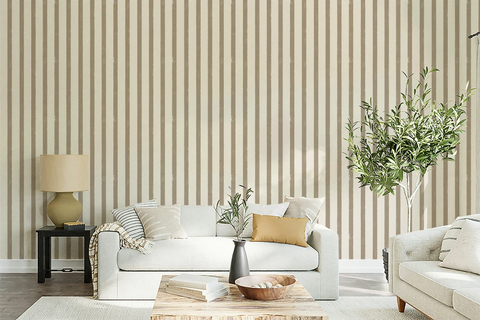 Living room with greige textured striped wallpaper, white sofa, and decorative elements.
