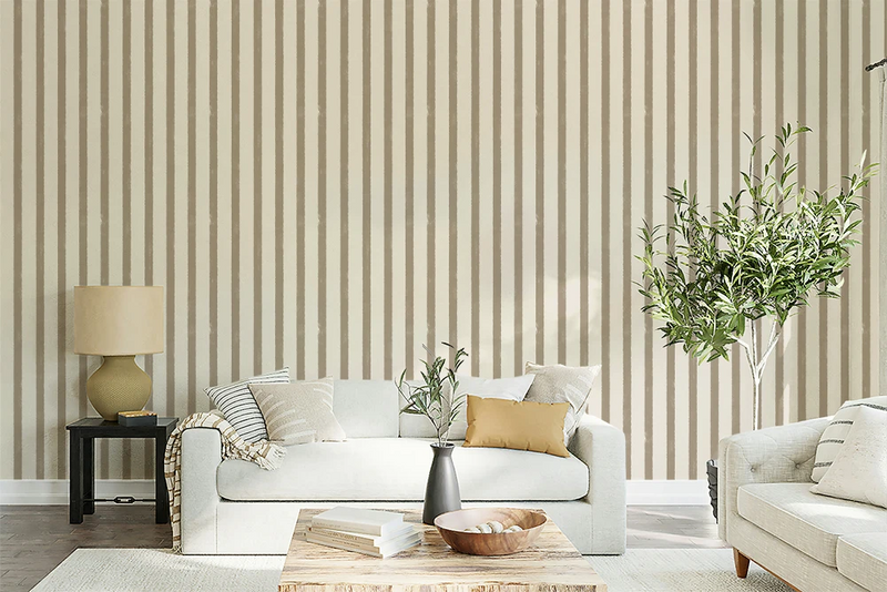 Living room with greige textured striped wallpaper, white sofa, and decorative elements.