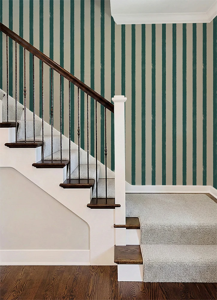 Staircase with wooden railings and striped green and white wallpaper.
