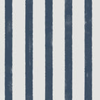 A close-up of a striped pattern featuring vertical navy blue stripes with a textured, hand-painted look on an off-white background.