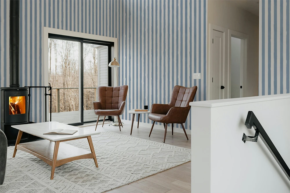 Modern living room with wooden coffee table, brown armchairs, and striped wallpaper.