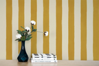 Hand painted wallpaper with stripes of cream and yellow. 
