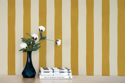 Hand painted wallpaper with stripes of cream and yellow. 