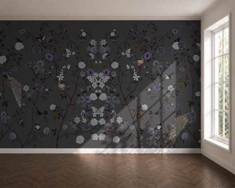 Room with floral chinoiserie wallpaper on a dark wall and a window letting in natural light.