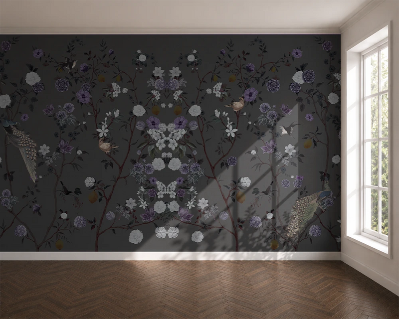 Room with floral chinoiserie wallpaper on a dark wall and a window letting in natural light.