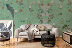 Living room with floral chinoiserie wallpaper, gray sofa, a dog, and decorative items.