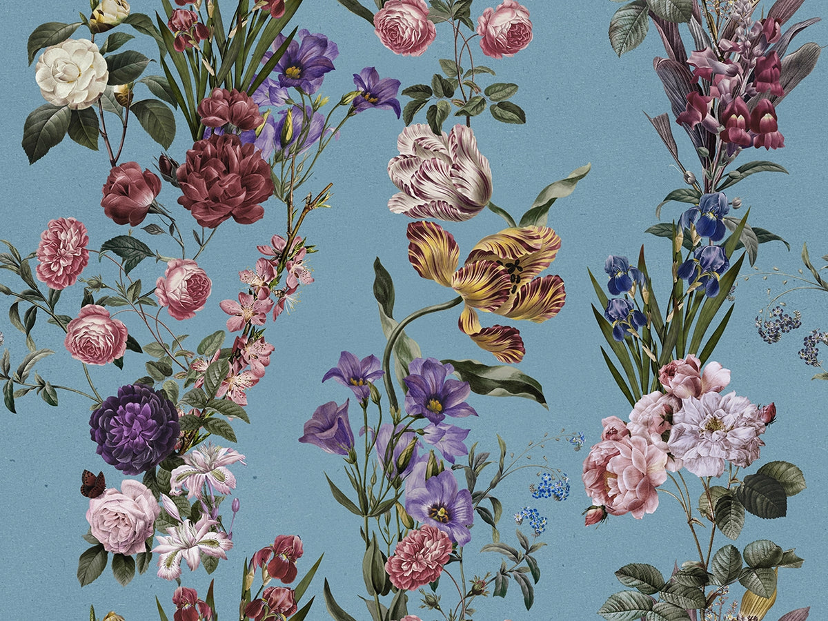 A vintage botanical pattern featuring an assortment of flowers including pink roses, purple irises, yellow tulips, and white blossoms on a dusty blue background.