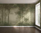 A large wallpaper mural depicting a misty olive-green forest with tall trees and soft light beams, installed on a room wall above a dark wood herringbone floor, with a white window on the right.