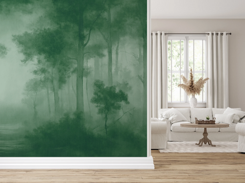 A large wallpaper mural featuring a misty green forest scene, shown installed on a wall in a modern living room with a white sofa, window, and light wood floor.
