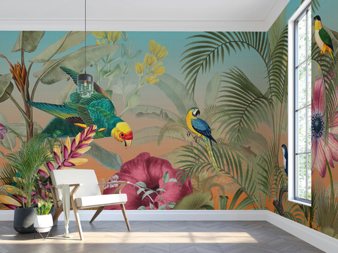 A tropical jungle wallpaper mural featuring colorful parrots, palm leaves, and large pink flowers, shown in a styled room with a white armchair, potted plants, and a window.