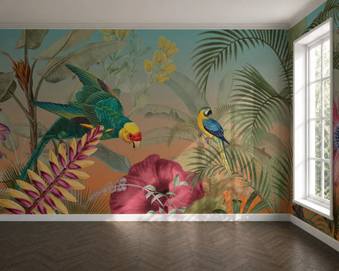 A tropical jungle wallpaper mural featuring colorful parrots, palm leaves, and large pink flowers, shown installed on a room's wall above a dark wood herringbone floor.