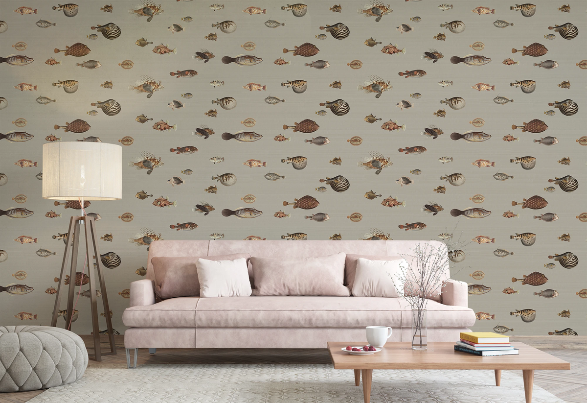 Modern living room with a grey sofa, floor lamp, and a wallpaper with a greige background featuring a pattern of vintage marine life illustrations. 