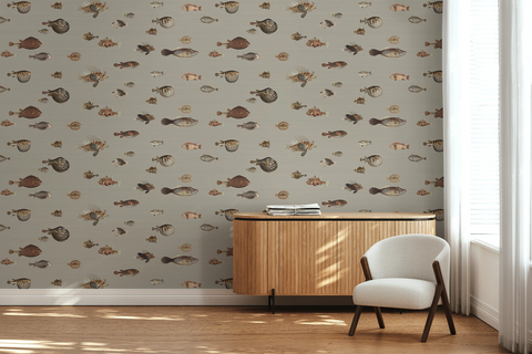 Lounge room with a wooden side table, a white arm chair, and a wallpaper with a greige background featuring a pattern of vintage marine life illustrations. 