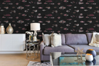 Living room with a blue sofa, a white sideboard, decorative items, and a wallpaper with a black background featuring a pattern of vintage marine life illustrations. 