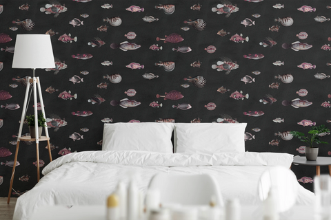 Bedroom with white beddings, a floor lamp, and a black wallpaper with a pattern of richly detailed, hand drawn vintage fish.