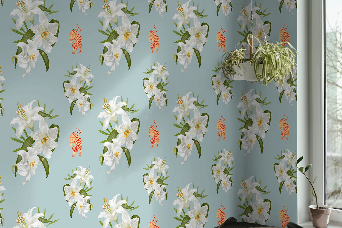 Tiffany blue wallpaper with a repeating pattern of white lilies, green leaves, and small orange tiger illustrations, shown installed on a wall in a room corner with a window and potted plants.